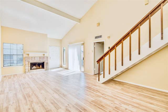 6103 Ludington Dr Unit 4-941, Houston, TX 77035 - unfurnished living room featuring beamed ceiling, high vaulted ceiling, stairway, wood finished floors, and baseboards