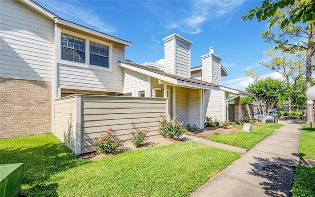 6103 Ludington Dr Unit 4-941, Houston, TX 77035 - view of front of home featuring a chimney and brick siding