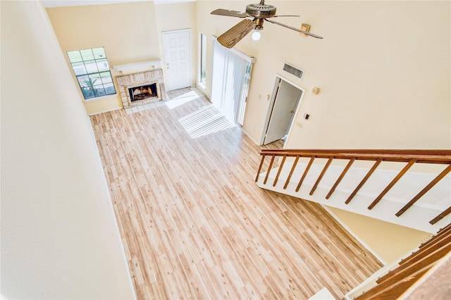 6103 Ludington Dr Unit 4-941, Houston, TX 77035 - staircase with a high ceiling, a ceiling fan, a fireplace with flush hearth, and wood finished floors