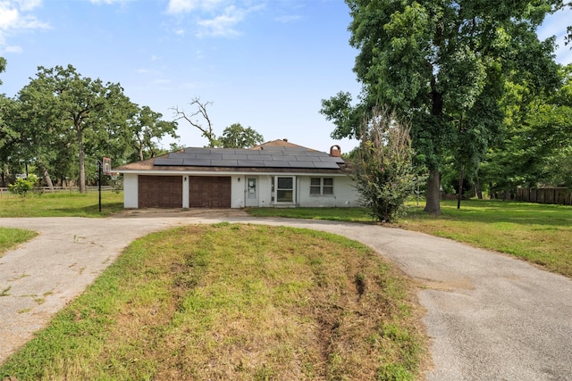 31302 Wisteria Rd, Magnolia, TX 77355 - ranch-style home featuring driveway, roof mounted solar panels, and an attached garage