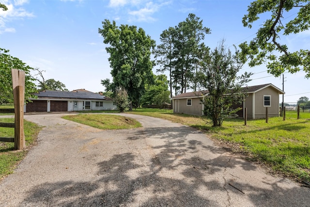 31302 Wisteria Rd, Magnolia, TX 77355 - single story home with driveway, roof mounted solar panels, and a garage