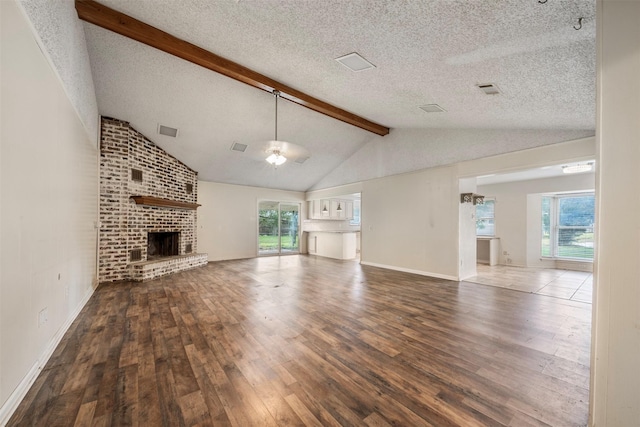 31302 Wisteria Rd, Magnolia, TX 77355 - unfurnished living room with hardwood / wood-style floors, healthy amount of natural light, a brick fireplace, a textured ceiling, and ceiling fan