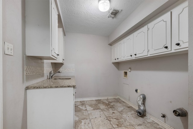 31302 Wisteria Rd, Magnolia, TX 77355 - washroom featuring hookup for a gas dryer, cabinet space, a textured ceiling, and washer hookup
