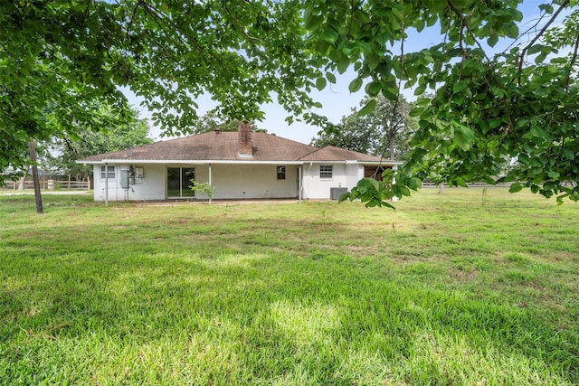 31302 Wisteria Rd, Magnolia, TX 77355 - rear view of property with a lawn and a chimney