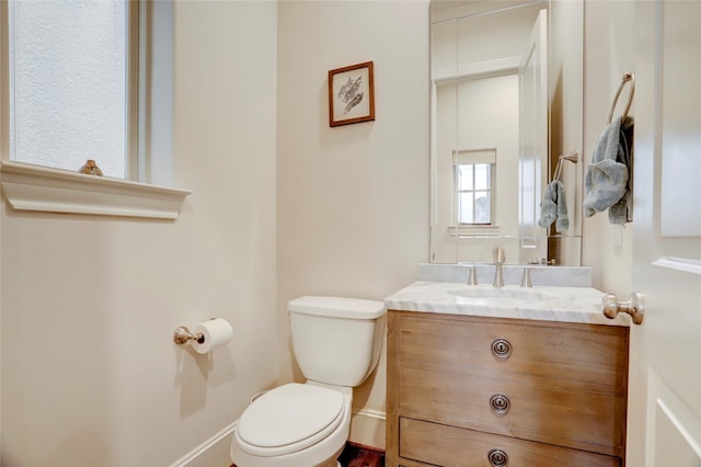 1348 W 25th St, Houston, TX 77008 - half bathroom featuring toilet, vanity, and baseboards