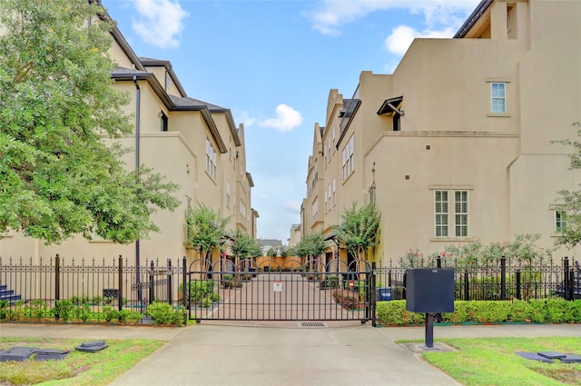 1348 W 25th St, Houston, TX 77008 - view of concrete road featuring a gated entry and a gate