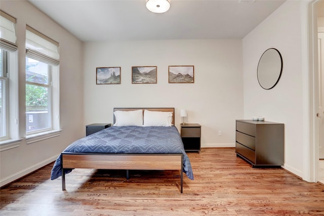 1348 W 25th St, Houston, TX 77008 - bedroom featuring light wood-style floors and baseboards