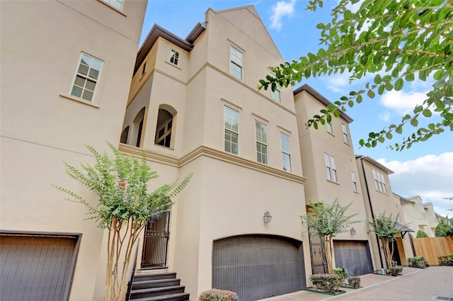 1348 W 25th St, Houston, TX 77008 - view of building exterior with a garage