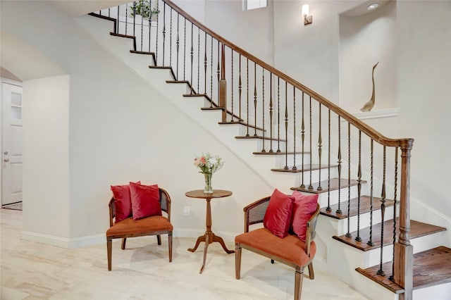 1348 W 25th St, Houston, TX 77008 - stairs with marble finish floors, arched walkways, and baseboards