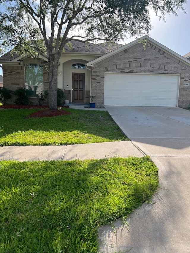 5215 Millwood Pass Cir, Richmond, TX 77407 - ranch-style home featuring brick siding, an attached garage, concrete driveway, and a front yard