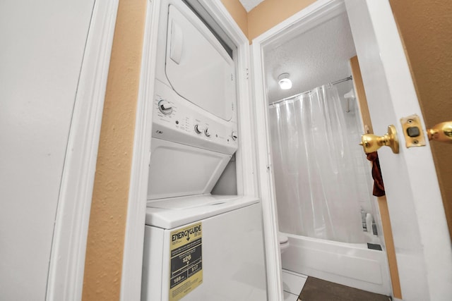 2750 Holly Hall St Unit 1104, Houston, TX 77054 - laundry room featuring stacked washing machine and dryer