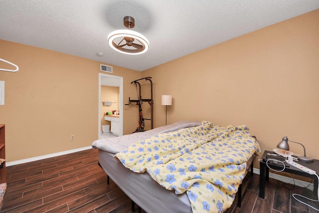 2750 Holly Hall St Unit 1104, Houston, TX 77054 - bedroom featuring wood finished floors, baseboards, and a textured ceiling