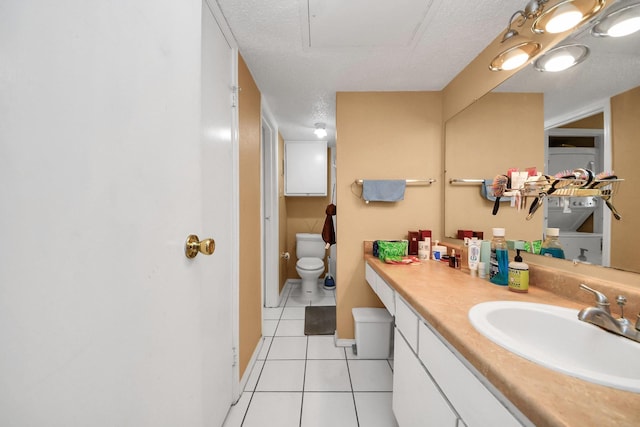 2750 Holly Hall St Unit 1104, Houston, TX 77054 - bathroom with toilet, tile patterned flooring, vanity, and a textured ceiling