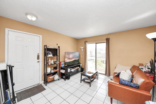 2750 Holly Hall St Unit 1104, Houston, TX 77054 - living room with a textured ceiling and light tile patterned floors