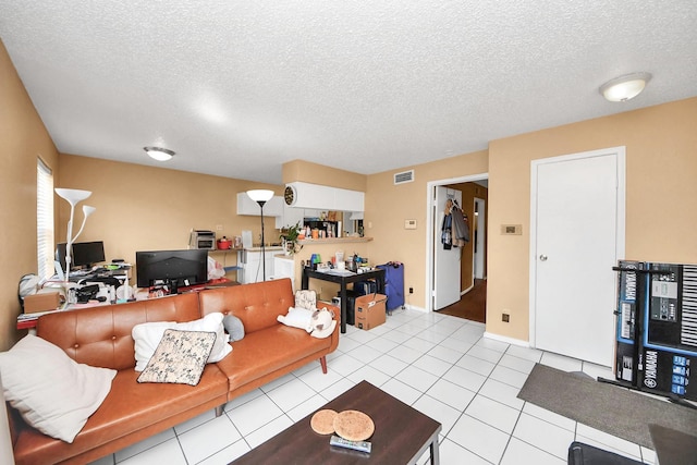 2750 Holly Hall St Unit 1104, Houston, TX 77054 - living area with a textured ceiling, an office area, baseboards, and tile patterned flooring