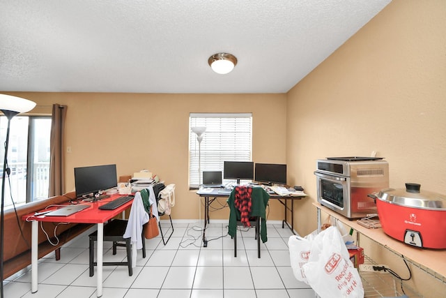2750 Holly Hall St Unit 1104, Houston, TX 77054 - office area with healthy amount of natural light, a textured ceiling, and baseboards
