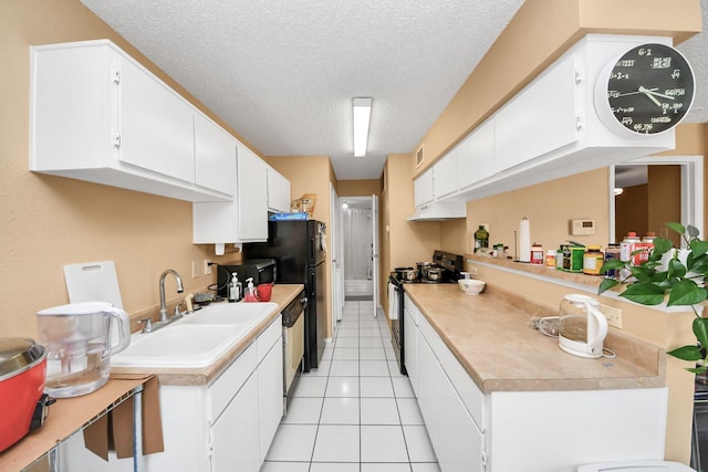 2750 Holly Hall St Unit 1104, Houston, TX 77054 - kitchen featuring electric range, a textured ceiling, a sink, light countertops, and under cabinet range hood