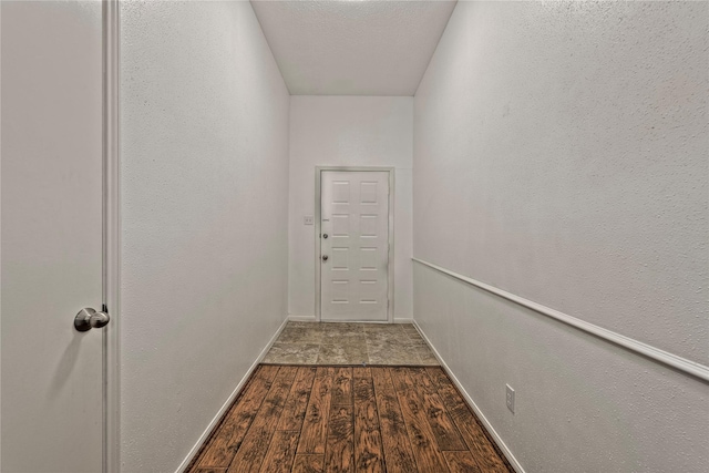 6493 Alisa Ln, Houston, TX 77084 - entryway with dark wood finished floors, a textured wall, and baseboards