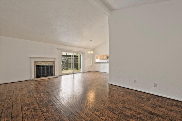 6493 Alisa Ln, Houston, TX 77084 - unfurnished living room with lofted ceiling, a textured ceiling, hardwood / wood-style floors, a premium fireplace, and a chandelier