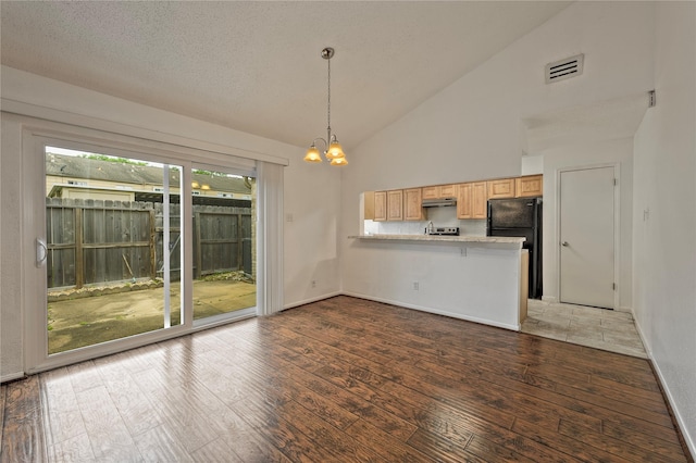6493 Alisa Ln, Houston, TX 77084 - kitchen with a peninsula, freestanding refrigerator, light brown cabinets, a chandelier, and light wood-style floors