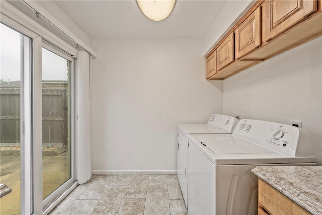 6493 Alisa Ln, Houston, TX 77084 - laundry room featuring washing machine and clothes dryer, baseboards, and cabinet space