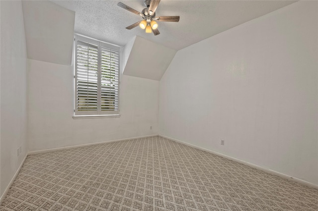 6493 Alisa Ln, Houston, TX 77084 - additional living space with ceiling fan, vaulted ceiling, a textured ceiling, carpet, and baseboards