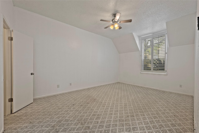 6493 Alisa Ln, Houston, TX 77084 - additional living space with a textured ceiling, a ceiling fan, carpet, lofted ceiling, and baseboards