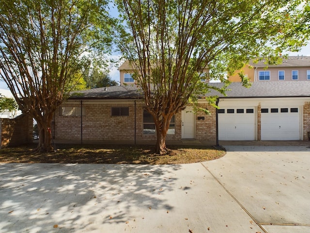5631 Winsome Ln, Houston, TX 77057 - view of front facade with driveway, brick siding, and a garage