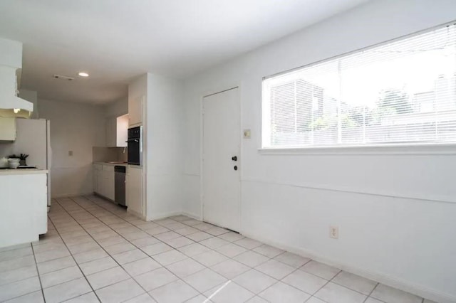 5631 Winsome Ln, Houston, TX 77057 - kitchen with black oven, light countertops, freestanding refrigerator, dishwasher, and light tile patterned flooring
