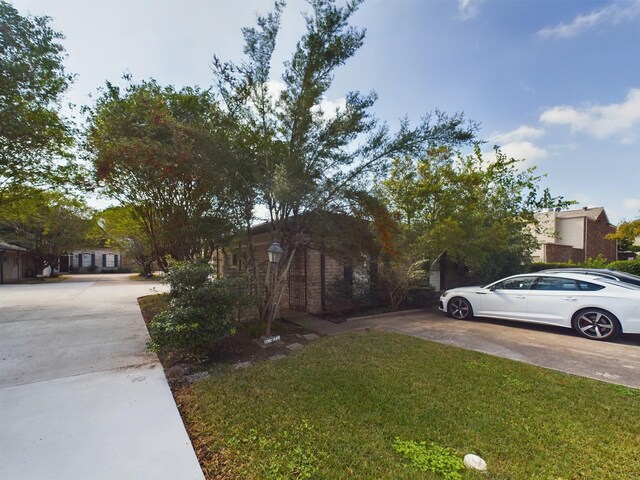 5631 Winsome Ln, Houston, TX 77057 - view of home's exterior featuring driveway and a lawn
