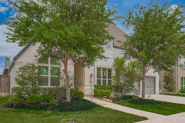 2206 Umber Oaks Ln, Brookshire, TX 77423 - view of property hidden behind natural elements with concrete driveway, stone siding, stucco siding, and a front yard