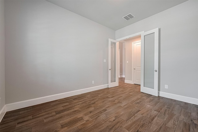 2206 Umber Oaks Ln, Brookshire, TX 77423 - empty room with dark wood-style floors, baseboards, and french doors