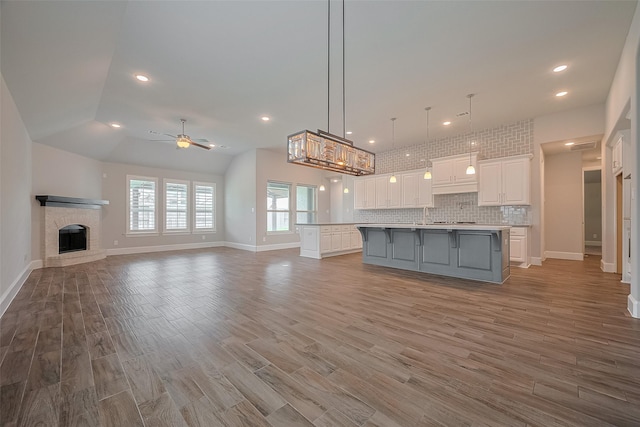 2206 Umber Oaks Ln, Brookshire, TX 77423 - kitchen featuring a large island with sink, white cabinetry, a ceiling fan, open floor plan, and recessed lighting