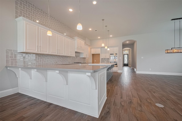 2206 Umber Oaks Ln, Brookshire, TX 77423 - kitchen with backsplash, white cabinets, dark wood-style floors, and recessed lighting