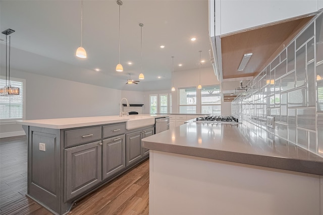 2206 Umber Oaks Ln, Brookshire, TX 77423 - kitchen with gray cabinets, wood finished floors, a ceiling fan, a sink, and recessed lighting