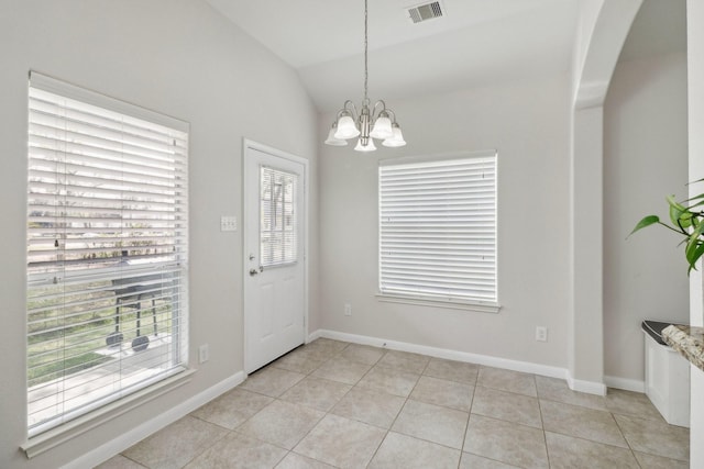 311 W Independence Dr, League City, TX 77573 - entryway with a chandelier, arched walkways, light tile patterned floors, lofted ceiling, and baseboards
