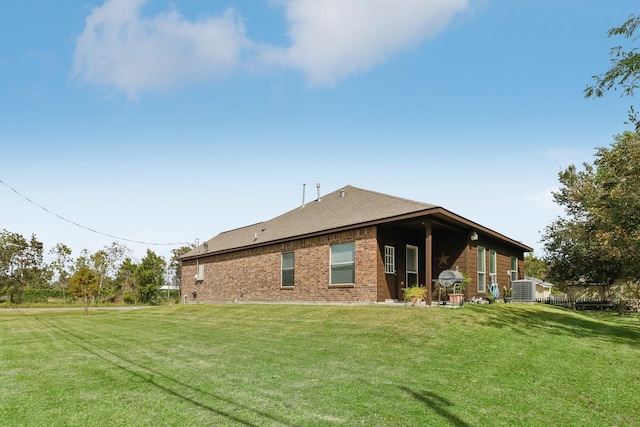 311 W Independence Dr, League City, TX 77573 - back of property featuring a yard, brick siding, and a shingled roof