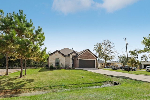 311 W Independence Dr, League City, TX 77573 - french country inspired facade featuring driveway, an attached garage, a front lawn, and stone siding