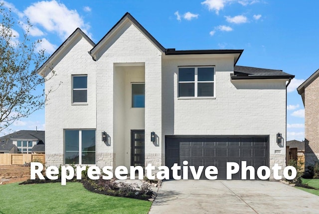 5041 Steady Breeze Dr, Katy, TX 77493 - view of front of home featuring an attached garage, brick siding, and concrete driveway