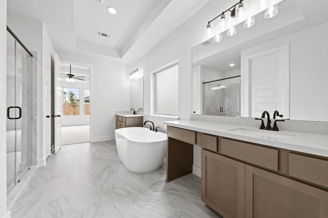 5041 Steady Breeze Dr, Katy, TX 77493 - bathroom featuring a marble finish shower, a raised ceiling, vanity, marble look tile flooring, and a freestanding bath