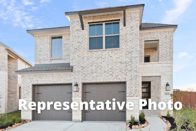24727 Lobelia Garden Ln, Katy, TX 77493 - view of front facade with concrete driveway, a garage, and stone siding