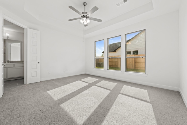 24718 Harrow Meadow Dr, Katy, TX 77493 - unfurnished bedroom featuring a tray ceiling, carpet floors, baseboards, and ceiling fan