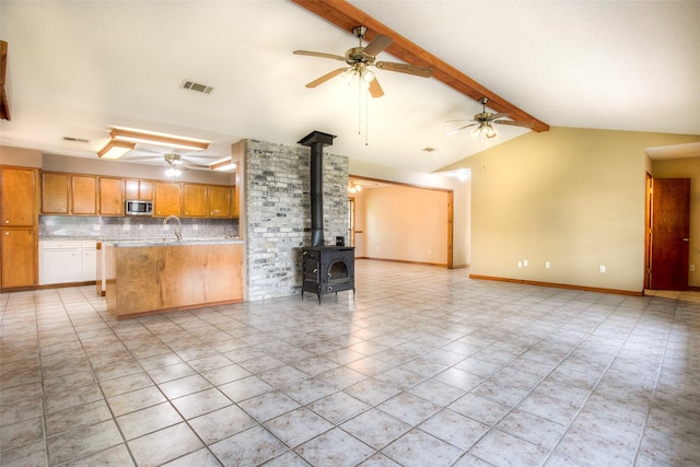 200 Cove View Dr, Trinity, TX 75862 - unfurnished living room with a wood stove, a ceiling fan, a sink, and baseboards