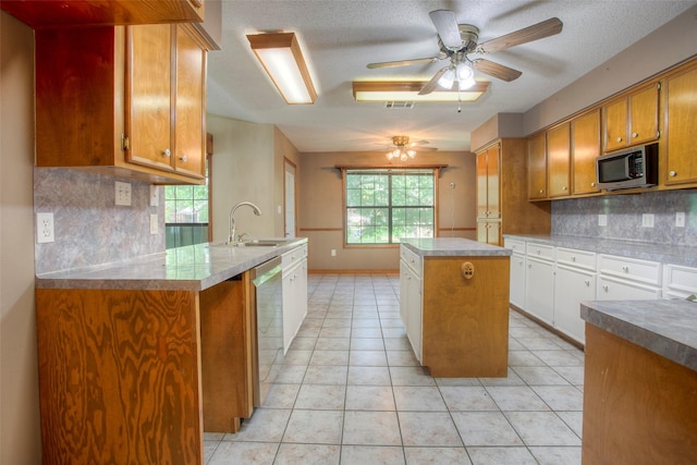 200 Cove View Dr, Trinity, TX 75862 - kitchen featuring stainless steel appliances, a sink, a ceiling fan, tasteful backsplash, and brown cabinetry