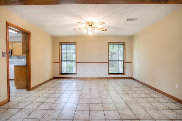 200 Cove View Dr, Trinity, TX 75862 - unfurnished room with a ceiling fan, a textured ceiling, baseboards, and light tile patterned floors