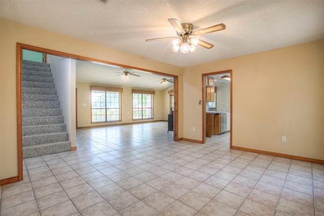 200 Cove View Dr, Trinity, TX 75862 - unfurnished room with stairway, ceiling fan, baseboards, a textured ceiling, and light tile patterned floors