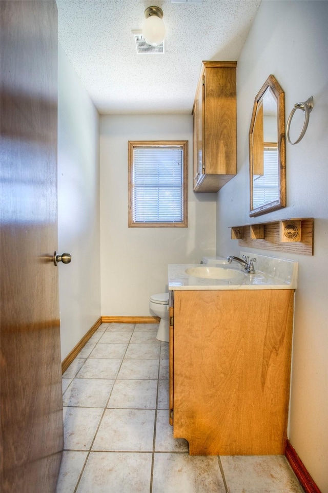 200 Cove View Dr, Trinity, TX 75862 - half bathroom with vanity, toilet, a textured ceiling, baseboards, and tile patterned flooring