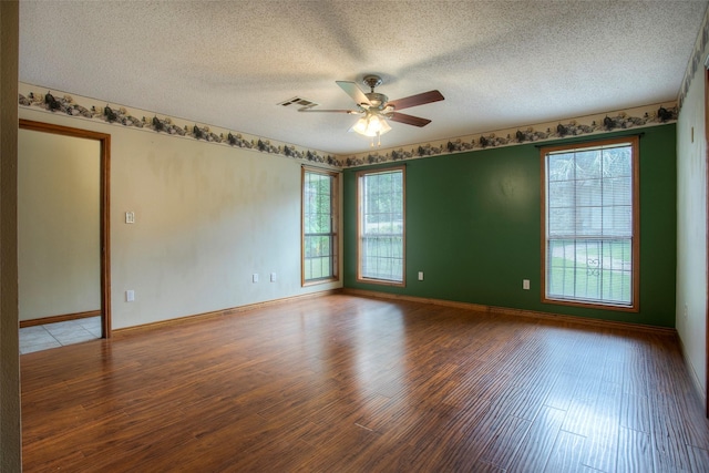 200 Cove View Dr, Trinity, TX 75862 - spare room featuring wood finished floors, plenty of natural light, ceiling fan, a textured ceiling, and baseboards