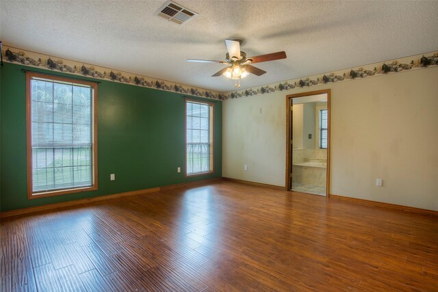 200 Cove View Dr, Trinity, TX 75862 - empty room featuring a textured ceiling, ceiling fan, wood finished floors, and baseboards
