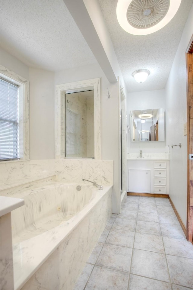 200 Cove View Dr, Trinity, TX 75862 - full bathroom featuring a textured ceiling, vanity, a tub with jets, tile patterned floors, and a shower stall